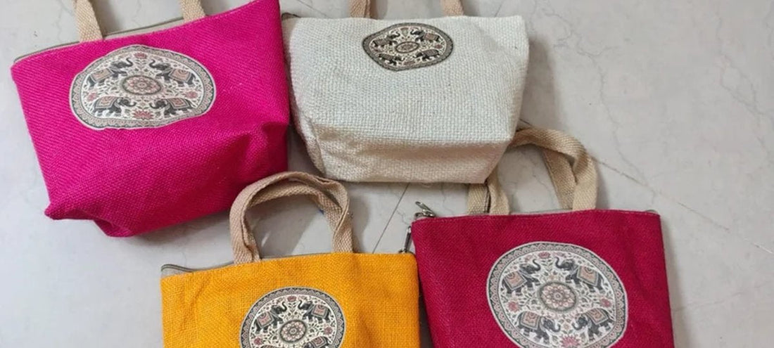 Colorful eco-friendly jute tote bags in pink, white, yellow, and red with traditional elephant embroidery from PunyaPath's sustainable jute bags collection