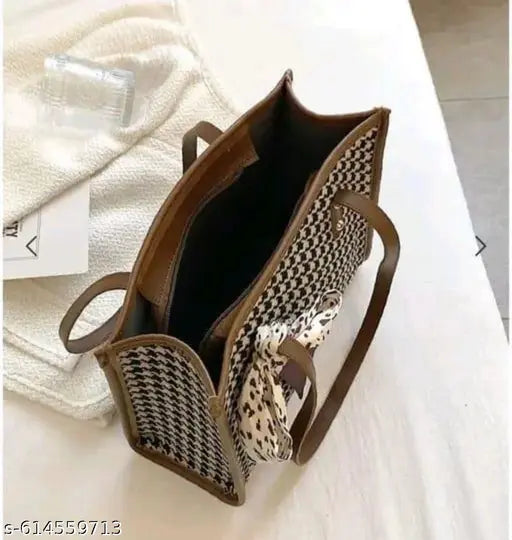 Design: Classic houndstooth check pattern with contrasting trims and a decorative bow scarf tied on the front. Material: Premium fabric body with faux leather handles and edges for durability.