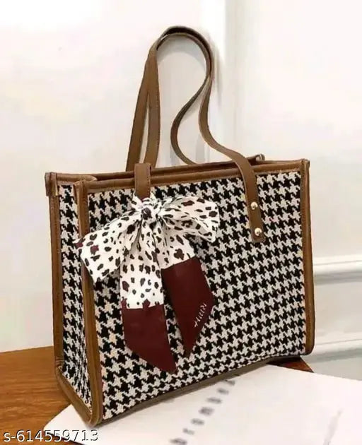 Design: Classic houndstooth check pattern with contrasting trims and a decorative bow scarf tied on the front. Material: Premium fabric body with faux leather handles and edges for durability.