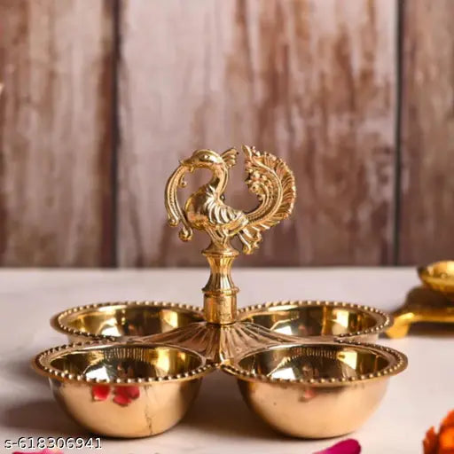 Gold-colored decorative item with multiple bowls on a wooden surface