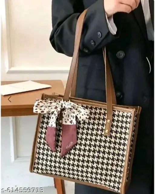 Design: Classic houndstooth check pattern with contrasting trims and a decorative bow scarf tied on the front. Material: Premium fabric body with faux leather handles and edges for durability.